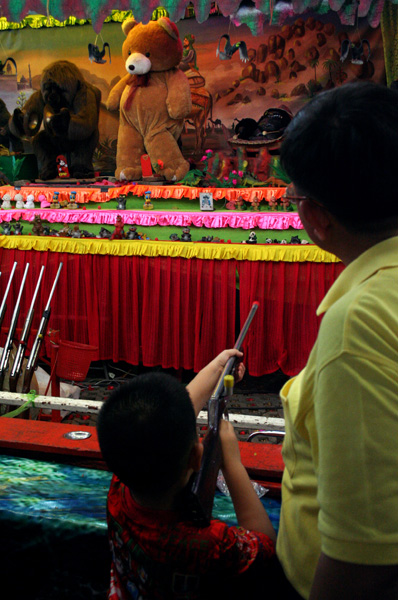 Boy at a shooting game, Golden Mount Temple Fair, Bangkok.